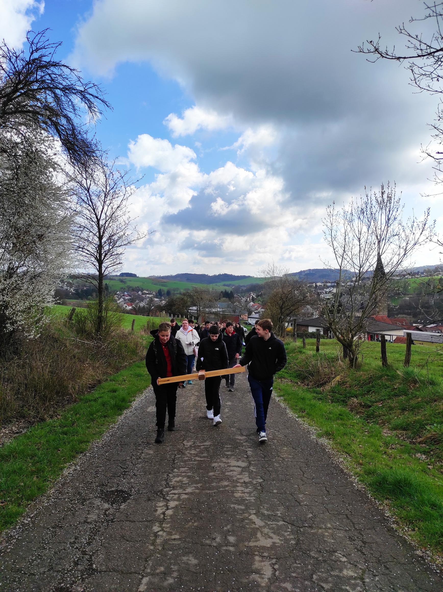 Jugendliche gehen den Kreuzweg im Freien